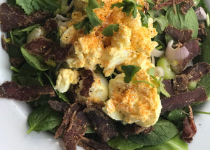 biltong salad with egg on white plate